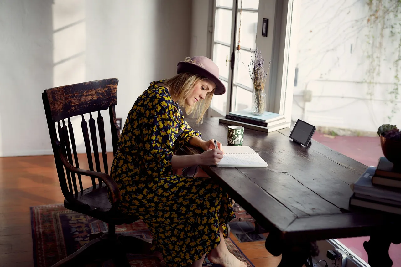 Writer working on a draft at a desk.